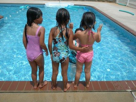 Back view of swimming friends